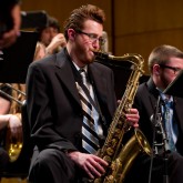 Member of the Buffalo State Jazz Ensemble playing the saxophone